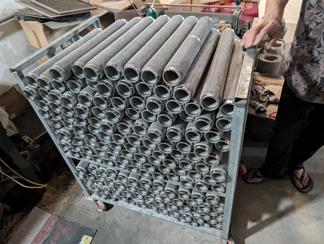 Formed metal filter tubes photographed at the workshop in August 2024